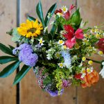 assorted-color flowers on brown wood
