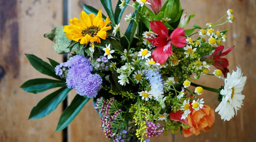 assorted-color flowers on brown wood
